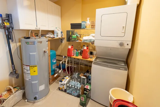 a view of a house with a big yard potted plants and wooden fence