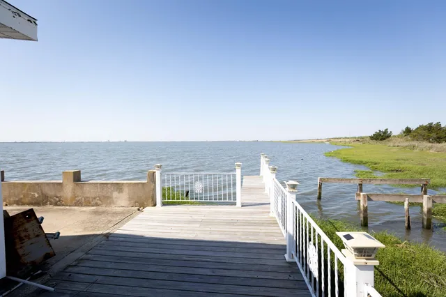 a living room with furniture a chandelier and a window