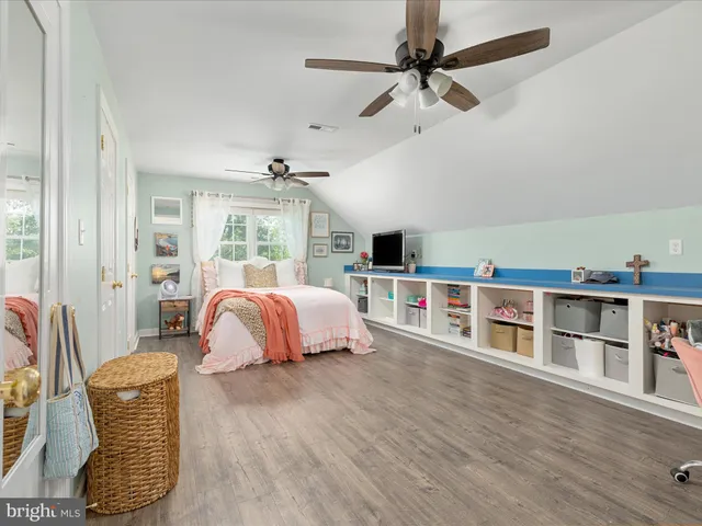 a spacious bedroom with a bed and a window