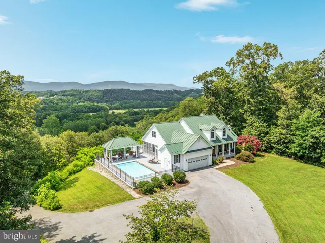 a front view of a house with a small park