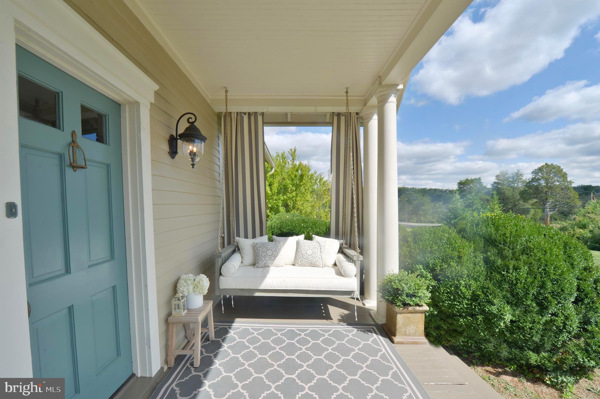 8478 Springs Road Warrenton, VA 20186 - Photo 5 of 45 Deep seating swing bench. Privacy hedges surround