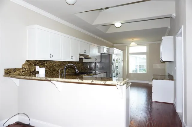 a view of living room with furniture and wooden floor