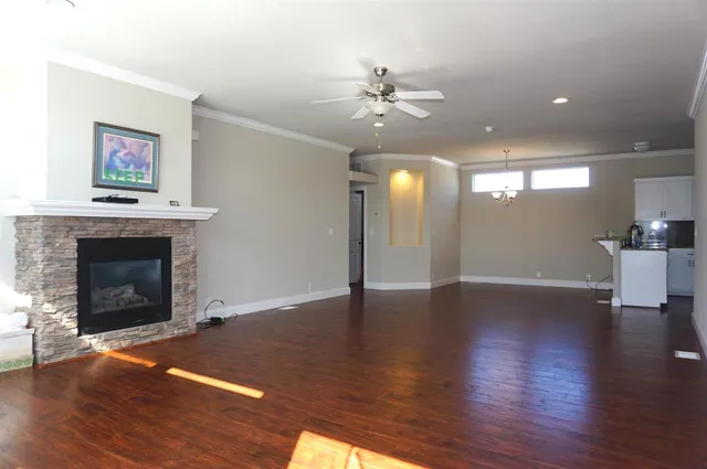a view of a livingroom with wooden floor and a fireplace