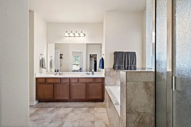 a spacious bathroom with a sink and a mirror