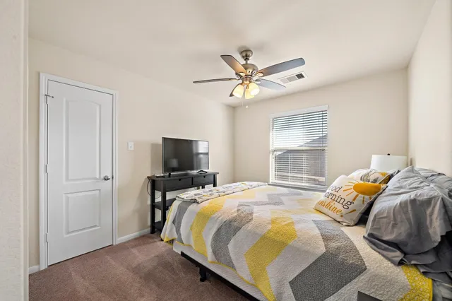 a bedroom with a bed and a tv