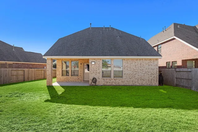 a view of a house with a yard and sitting area
