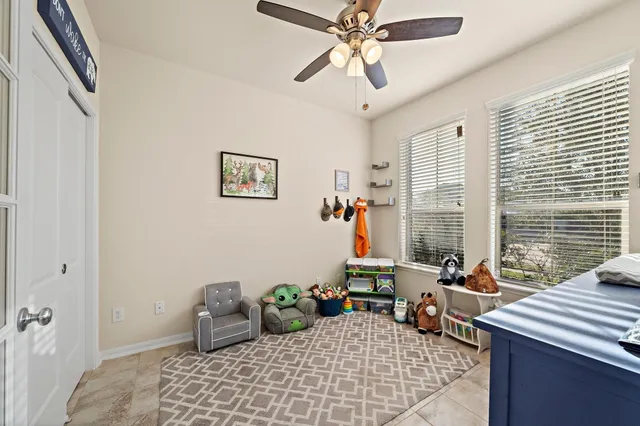 a view of a livingroom with workspace and a window