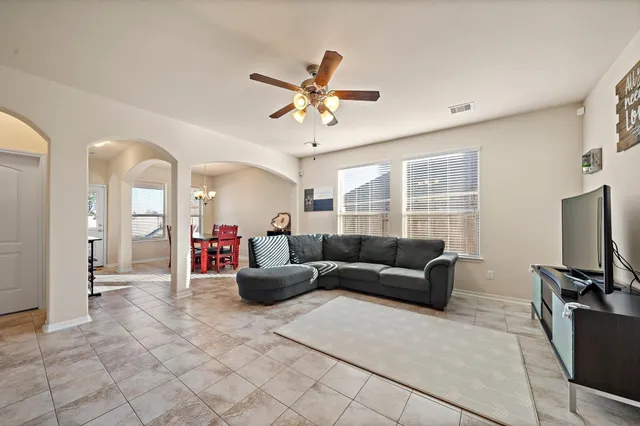 a living room with furniture and a flat screen tv
