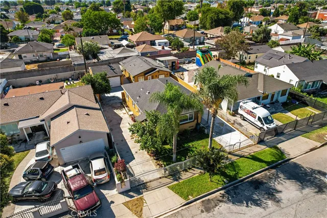 an aerial view of a house with a yard