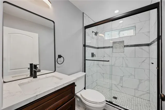 a kitchen with stainless steel appliances granite countertop a kitchen island a stove a table and chairs