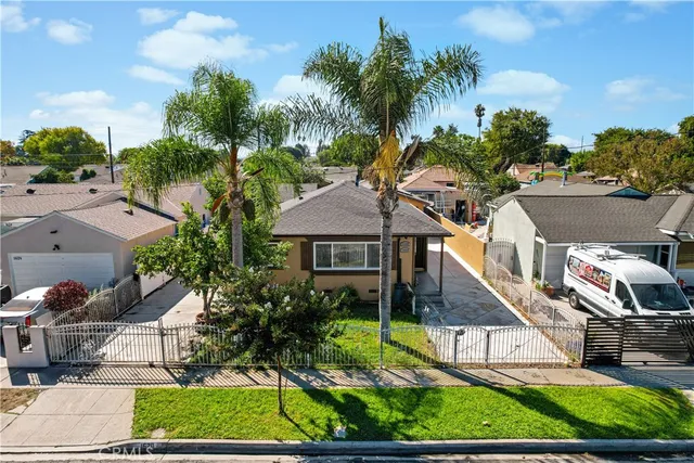 a aerial view of a house with a yard and potted plants