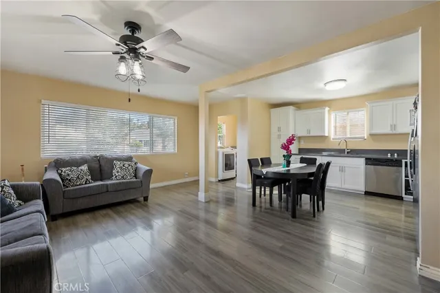 a living room with furniture and kitchen view
