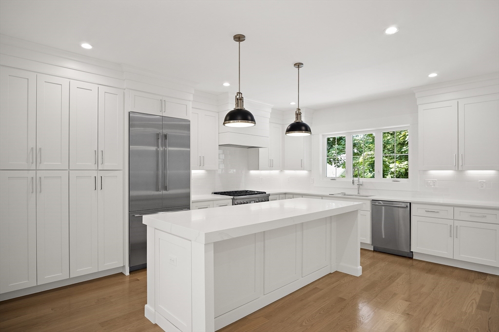 36 Avon Road Wellesley, MA 02482 - Photo 8 of 40 a kitchen with kitchen island a sink stainless steel appliances and window