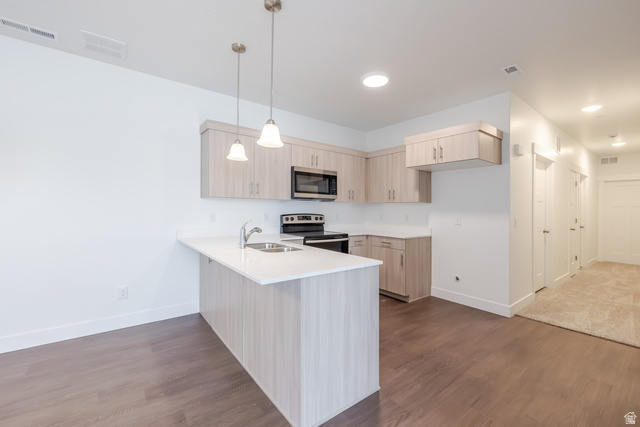 693 West 4500th South, Unit O202 Mapleton, UT 84664 - Photo 12 of 16 Kitchen featuring light wood finish cabinets, a peninsula, stainless steel appliances, and light stone counters
