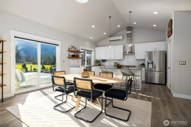 a kitchen with stainless steel appliances kitchen island granite countertop a refrigerator and a stove top oven