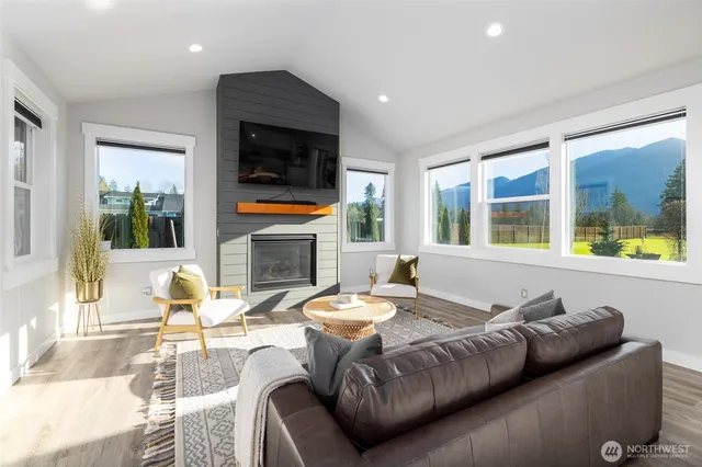 a living room with fireplace furniture and a flat screen tv