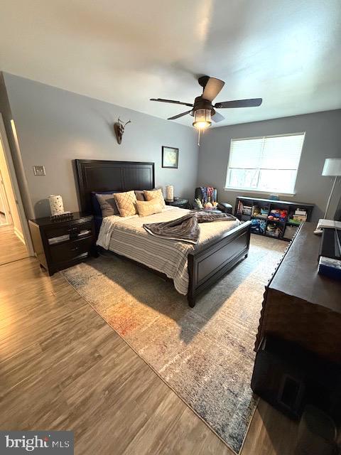 111 Village Walk Exton, PA 19341 - Photo 6 of 10 a spacious bedroom with a bed a couch and a chandelier