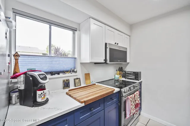 a kitchen with stainless steel appliances a sink a stove and a microwave