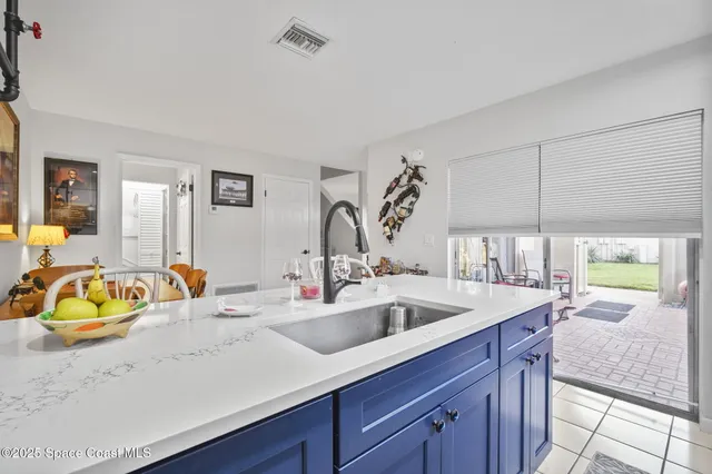 a kitchen with a sink and a wooden floor