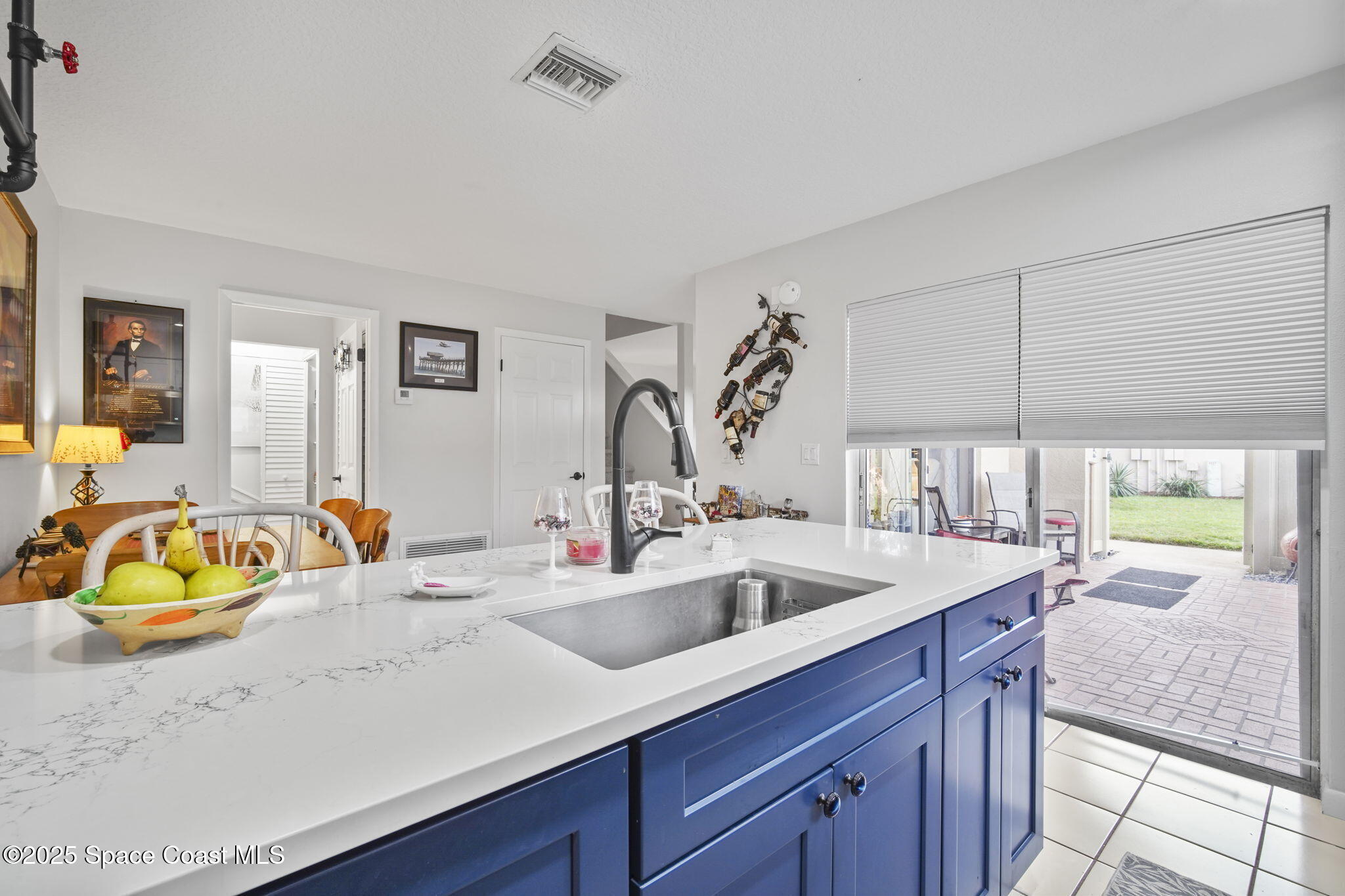 4148 Prime Avenue, Unit 1504 Rockledge, FL 32955 - Photo 15 of 30 a kitchen with a sink and a wooden floor