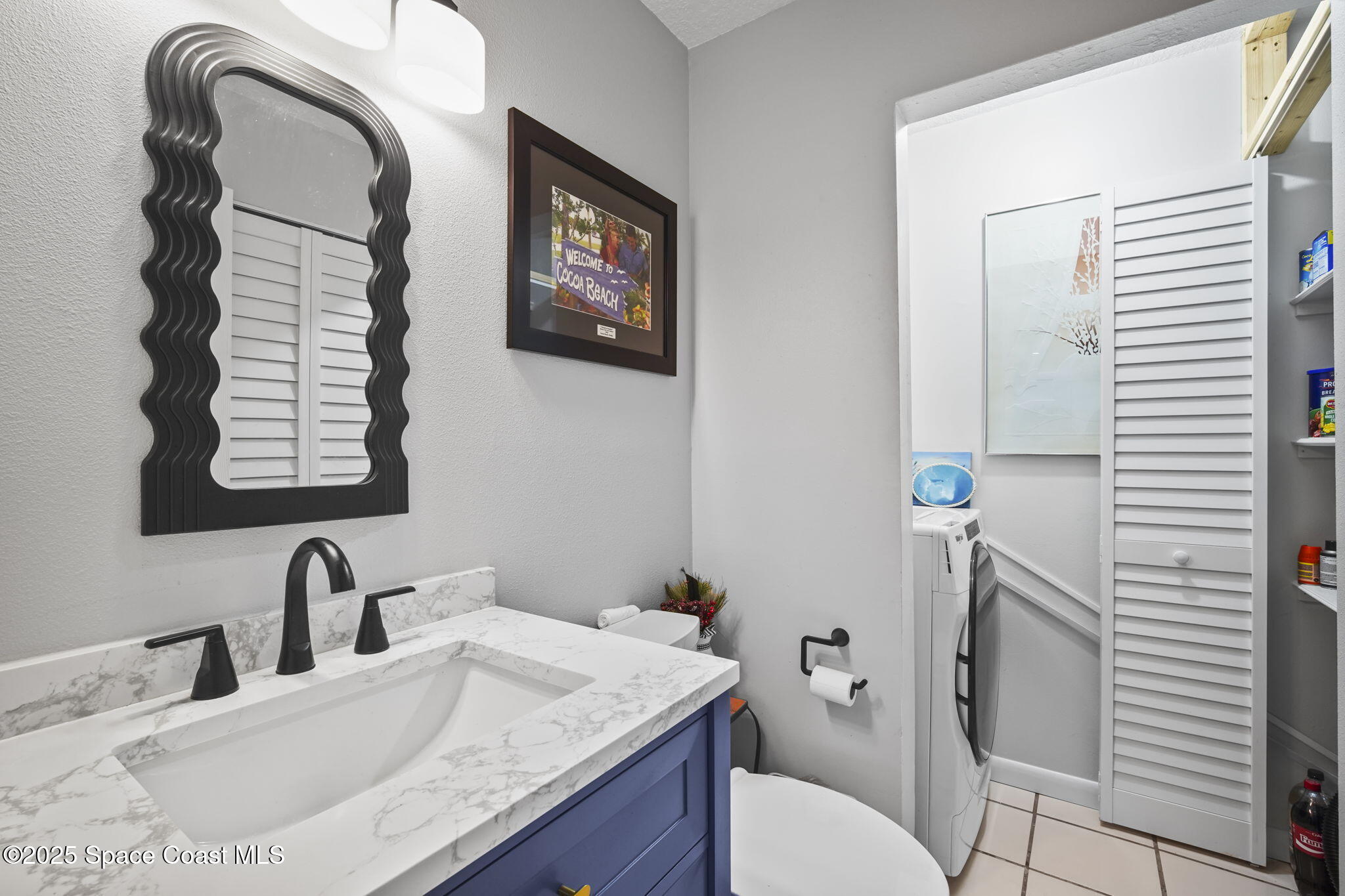 4148 Prime Avenue, Unit 1504 Rockledge, FL 32955 - Photo 17 of 30 a bathroom with a granite countertop toilet sink and mirror