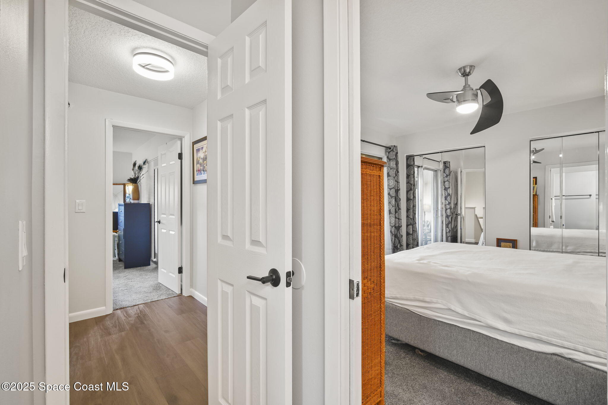 4148 Prime Avenue, Unit 1504 Rockledge, FL 32955 - Photo 22 of 30 a bedroom with a bed and a chandelier