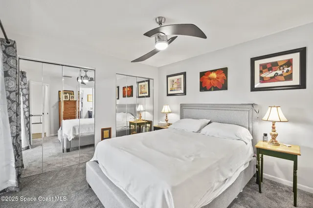 a spacious bedroom with a bed and glass wall painting