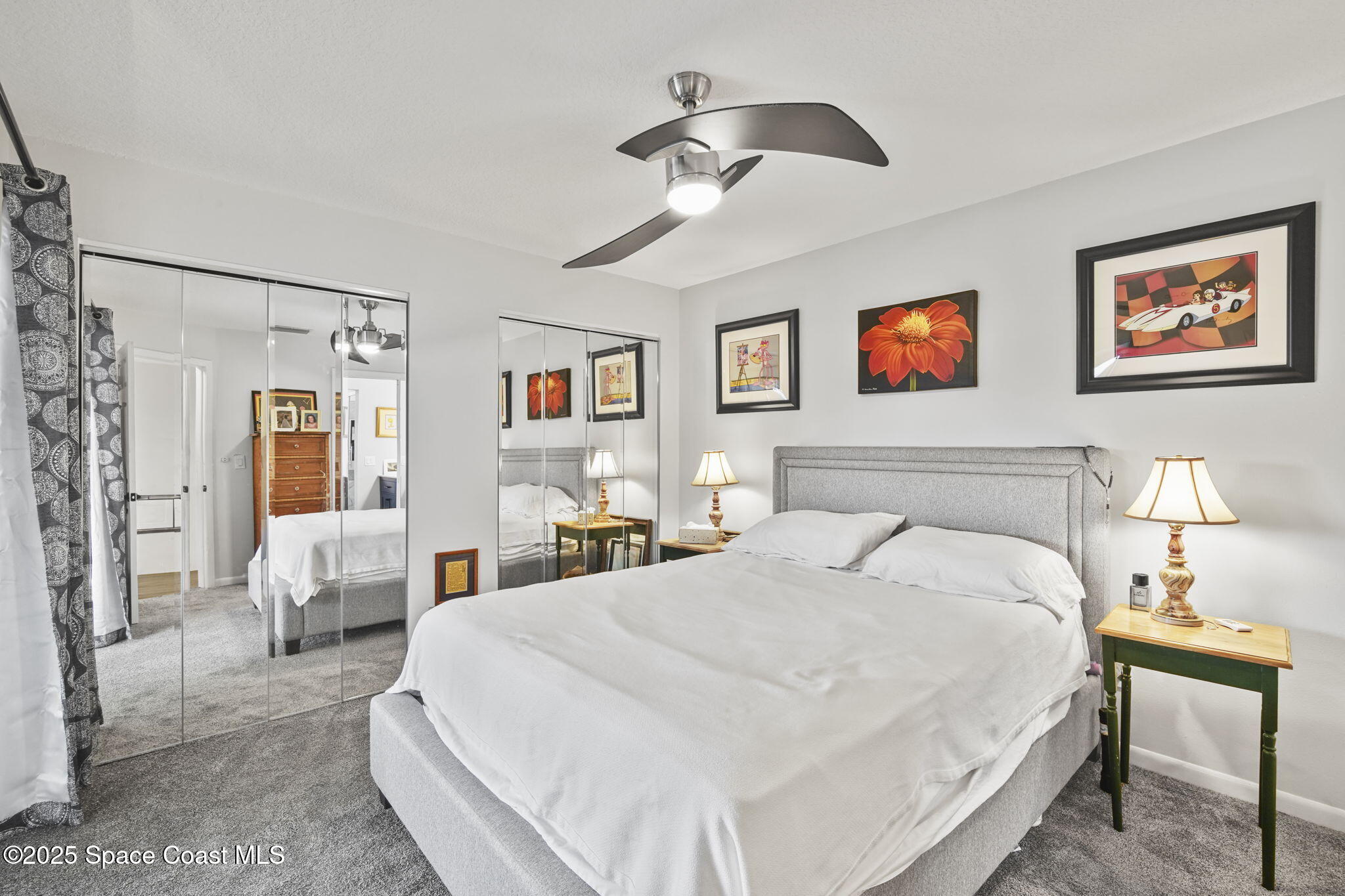 4148 Prime Avenue, Unit 1504 Rockledge, FL 32955 - Photo 23 of 30 a spacious bedroom with a bed and glass wall painting