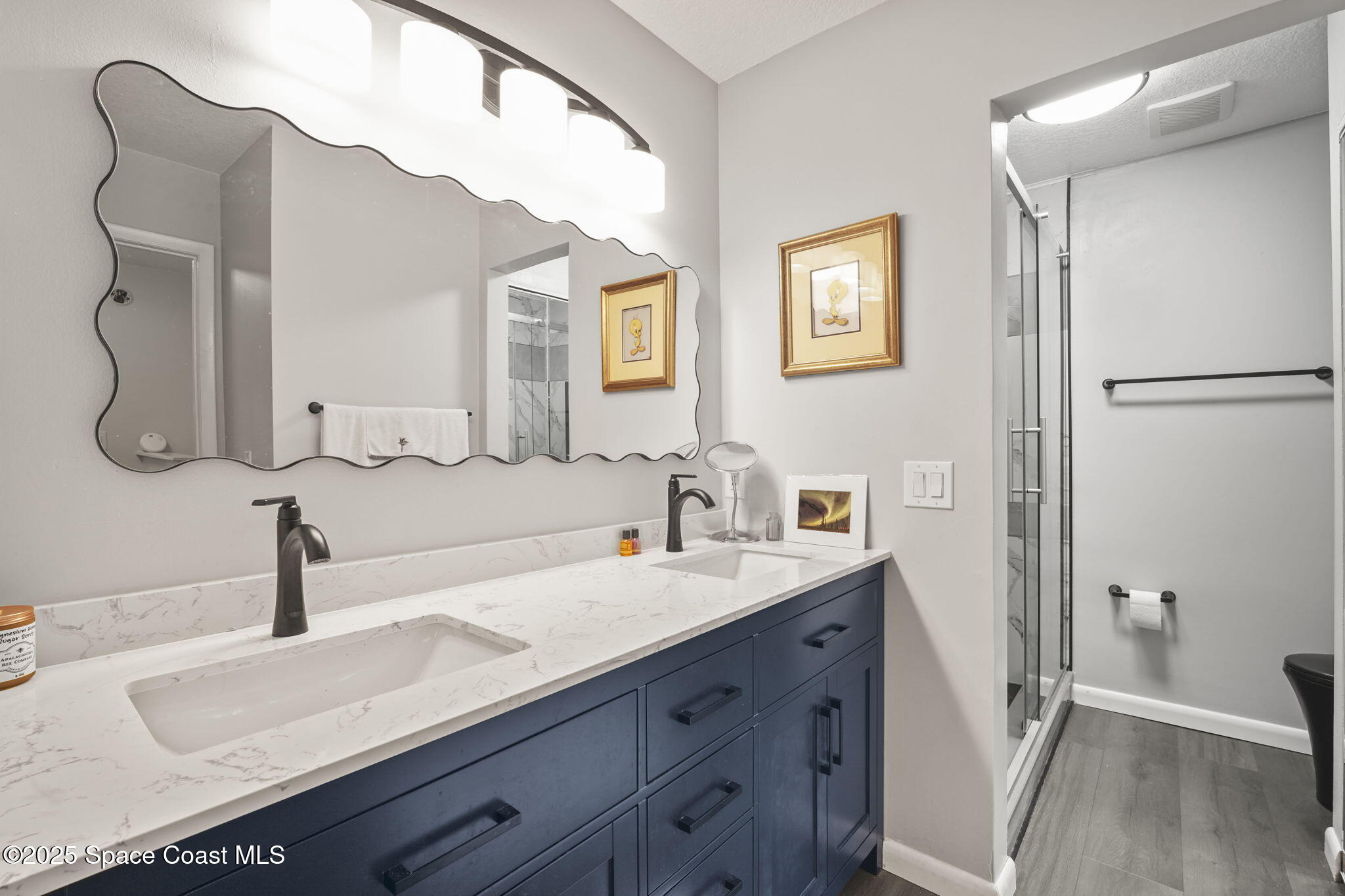 4148 Prime Avenue, Unit 1504 Rockledge, FL 32955 - Photo 25 of 30 a spacious bathroom with a double vanity sink and mirror