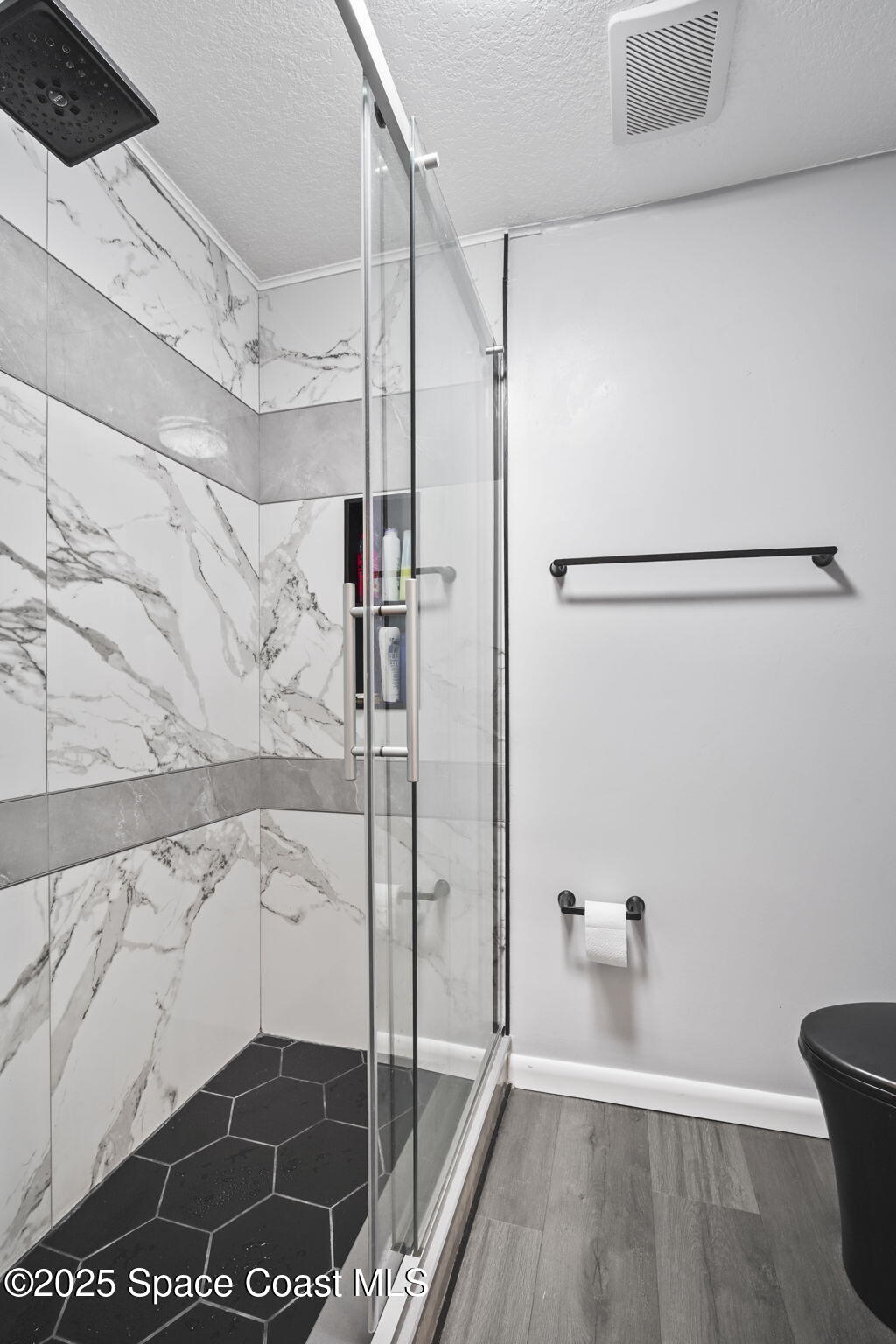 4148 Prime Avenue, Unit 1504 Rockledge, FL 32955 - Photo 26 of 30 a bathroom with a glass shower door