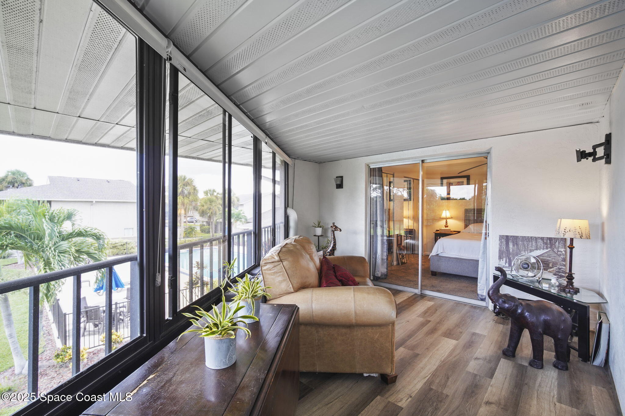 4148 Prime Avenue, Unit 1504 Rockledge, FL 32955 - Photo 27 of 30 a living room with furniture and floor to ceiling windows