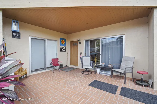 a living room with furniture a rug and white walls