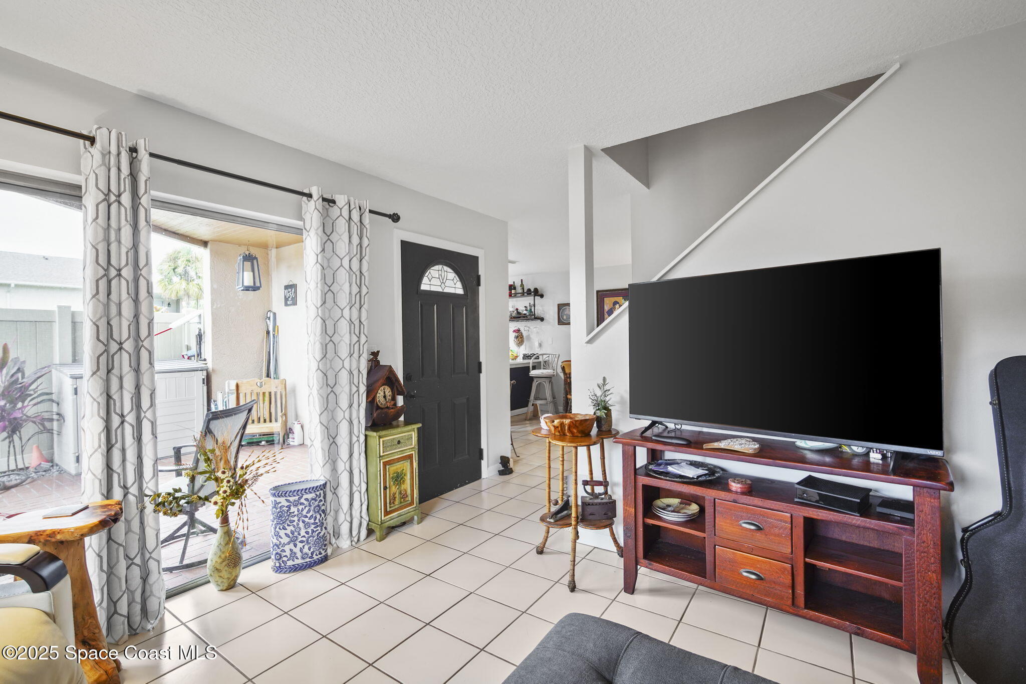 4148 Prime Avenue, Unit 1504 Rockledge, FL 32955 - Photo 7 of 30 a room with furniture and flat screen tv