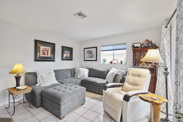 a living room with furniture and a lamp
