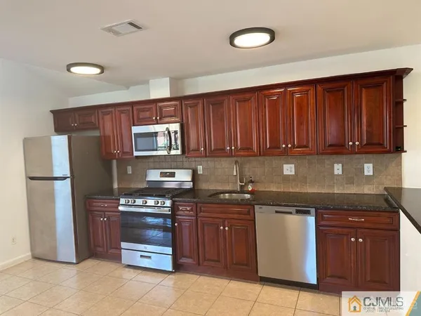 a kitchen with a sink and a refrigerator