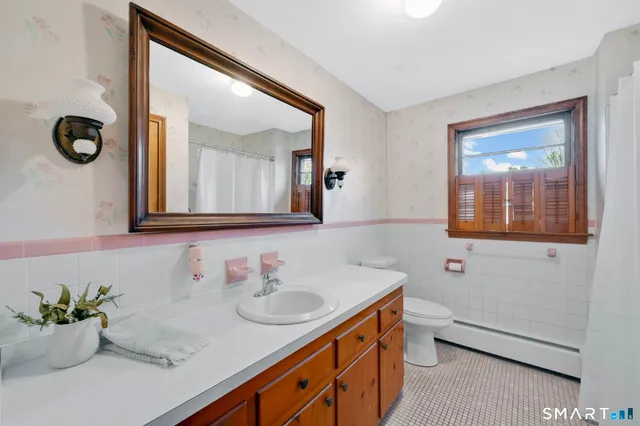 a bathroom with a granite countertop sink mirror and vanity