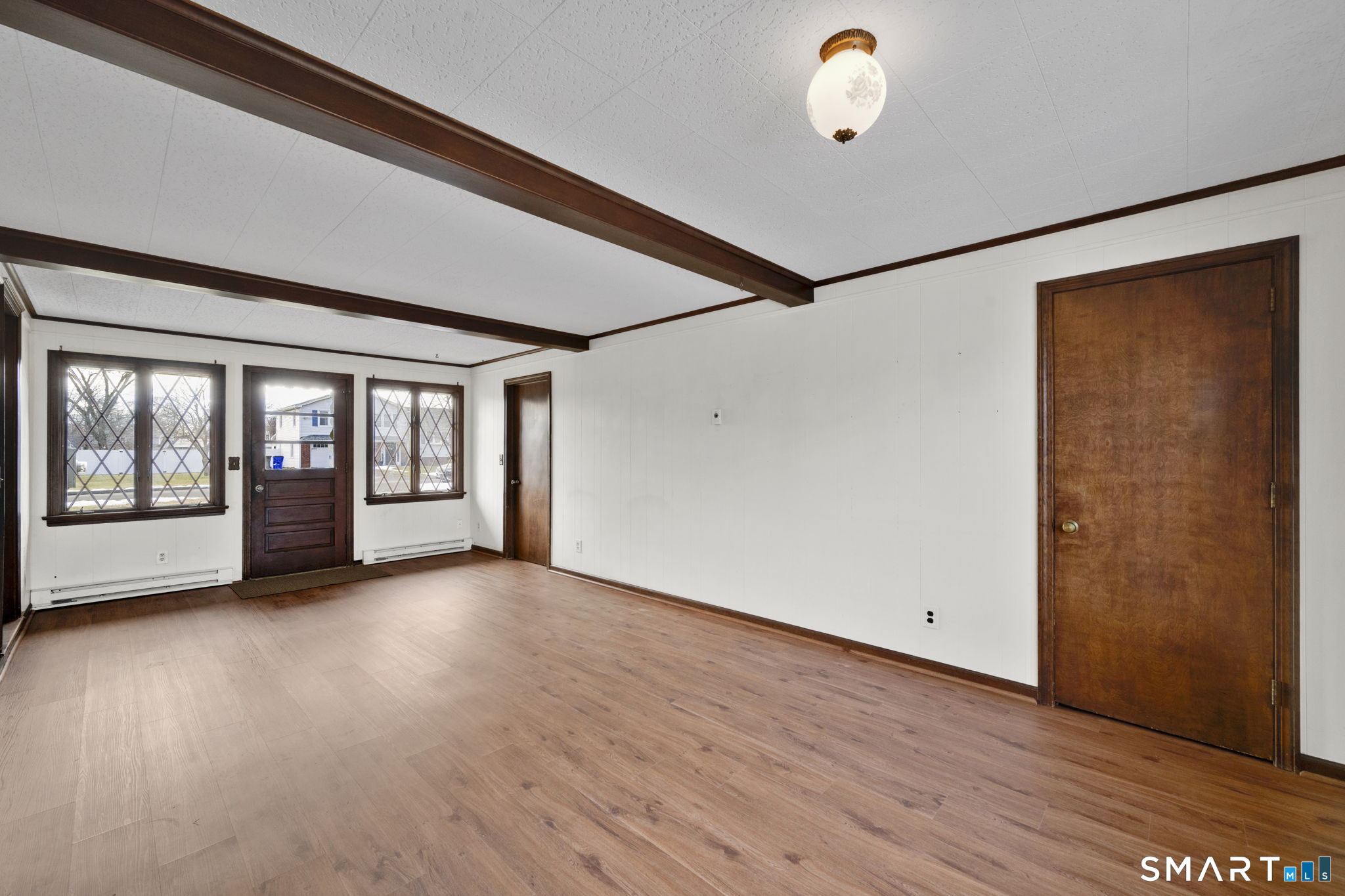 10 Helena Lane Windsor Locks, CT 06096 - Photo 2 of 36 a view of an empty room with wooden floor and a window