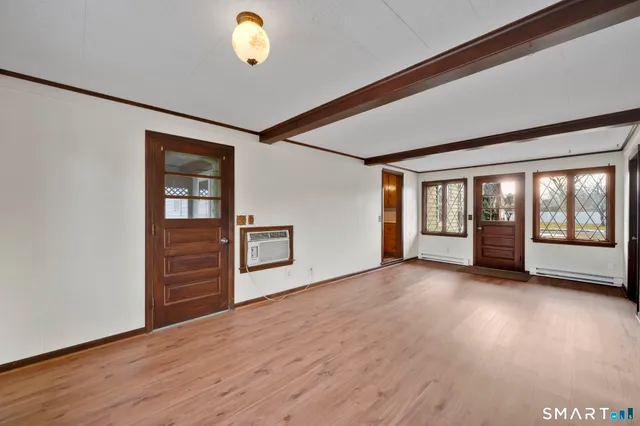 wooden floor in an empty room with a window