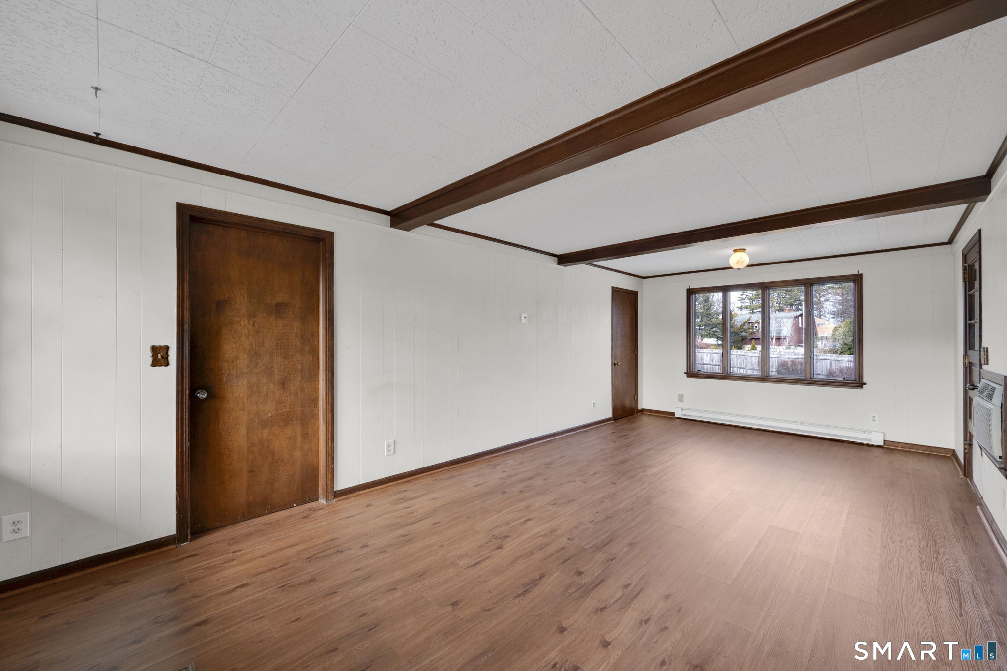 10 Helena Lane Windsor Locks, CT 06096 - Photo 4 of 36 a view of an empty room with wooden floor and a window