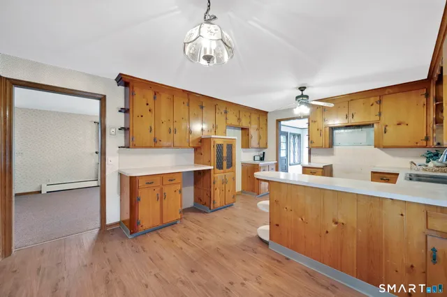 a kitchen with stainless steel appliances a sink cabinets and wooden floor