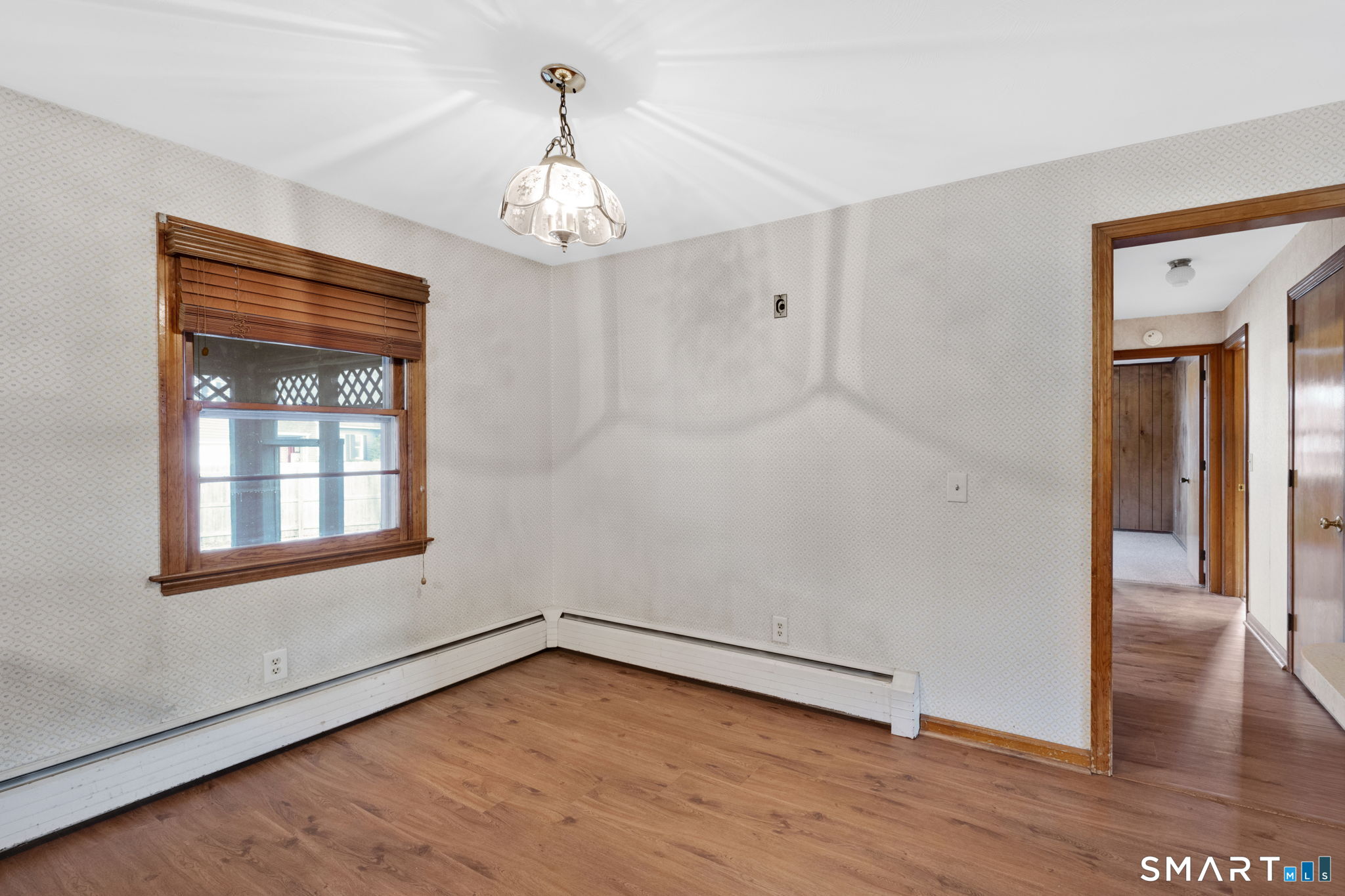 10 Helena Lane Windsor Locks, CT 06096 - Photo 10 of 36 a view of an empty room with wooden floor and a window