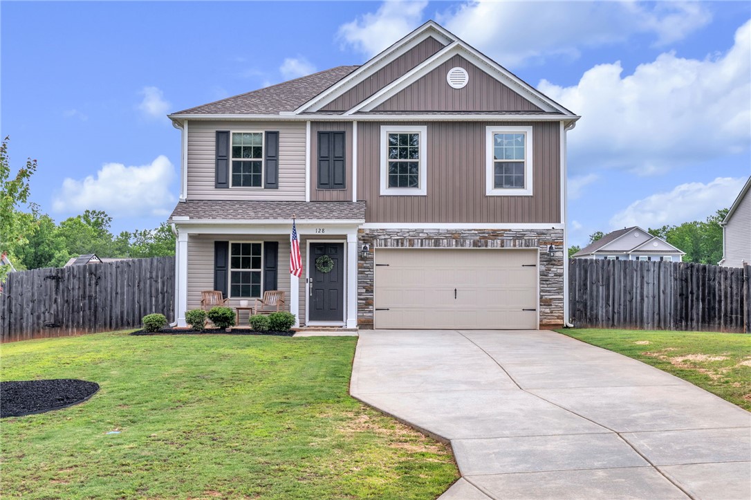 A well-maintained lawn and sturdy privacy fence frame this home's inviting facade.