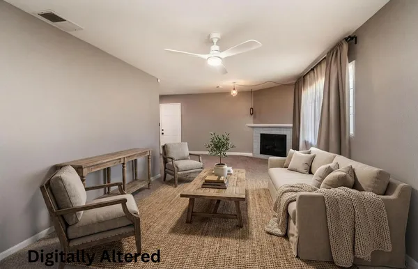 a living room with furniture and a fireplace