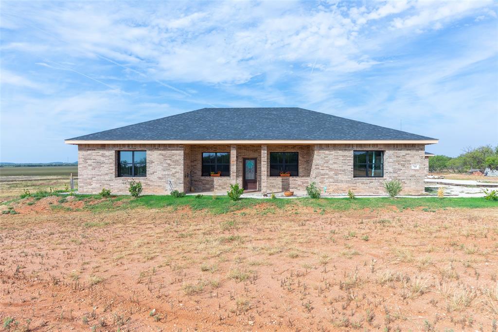 760 Wimberly Road Merkel, TX 79536 - Photo 2 of 35 Exterior brick facade with a dark shingle roof and black-framed windows