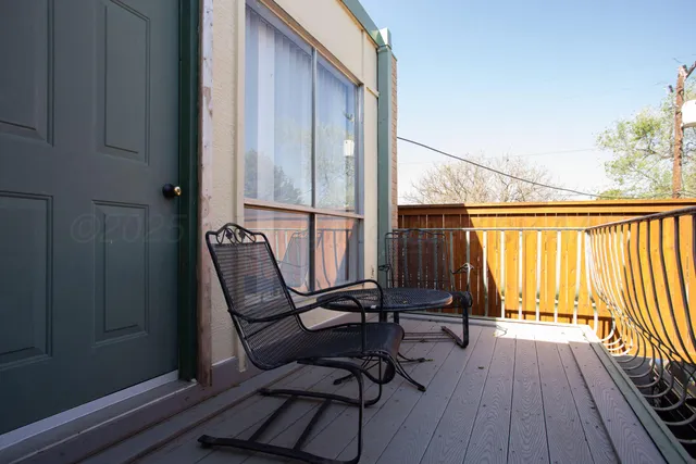 a view of a table and chairs in backyard of the house