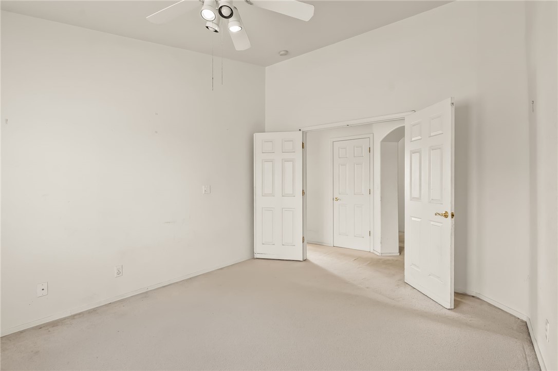 2853 Winchester Road Bullhead City, AZ 86442 - Photo 8 of 40 This room features neutral-toned carpeting, white walls, and a ceiling fan with integrated lighting