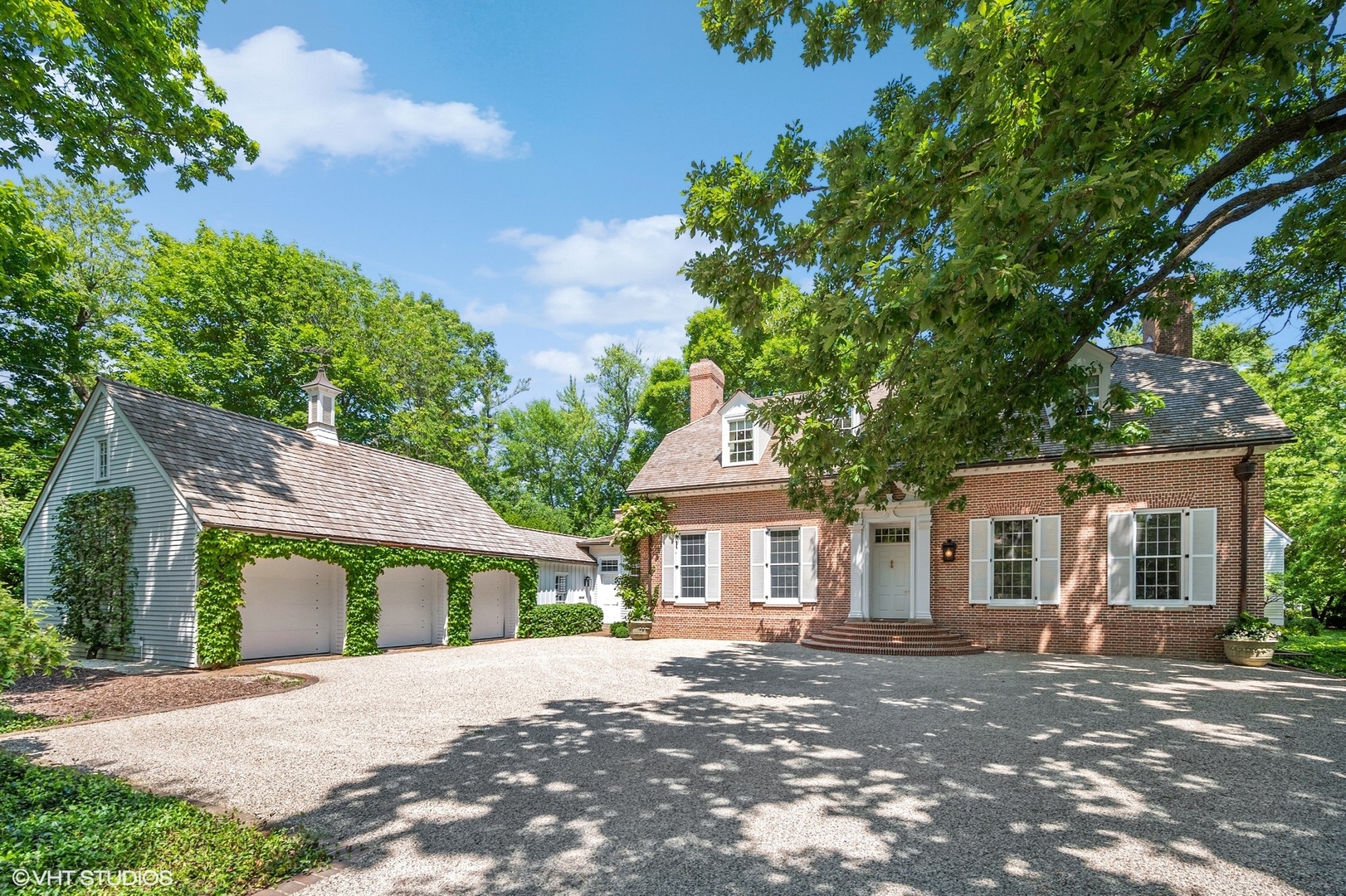 25 Indian Hill Road Winnetka, IL 60093 - Photo 1 of 84 a front view of a house with a garden
