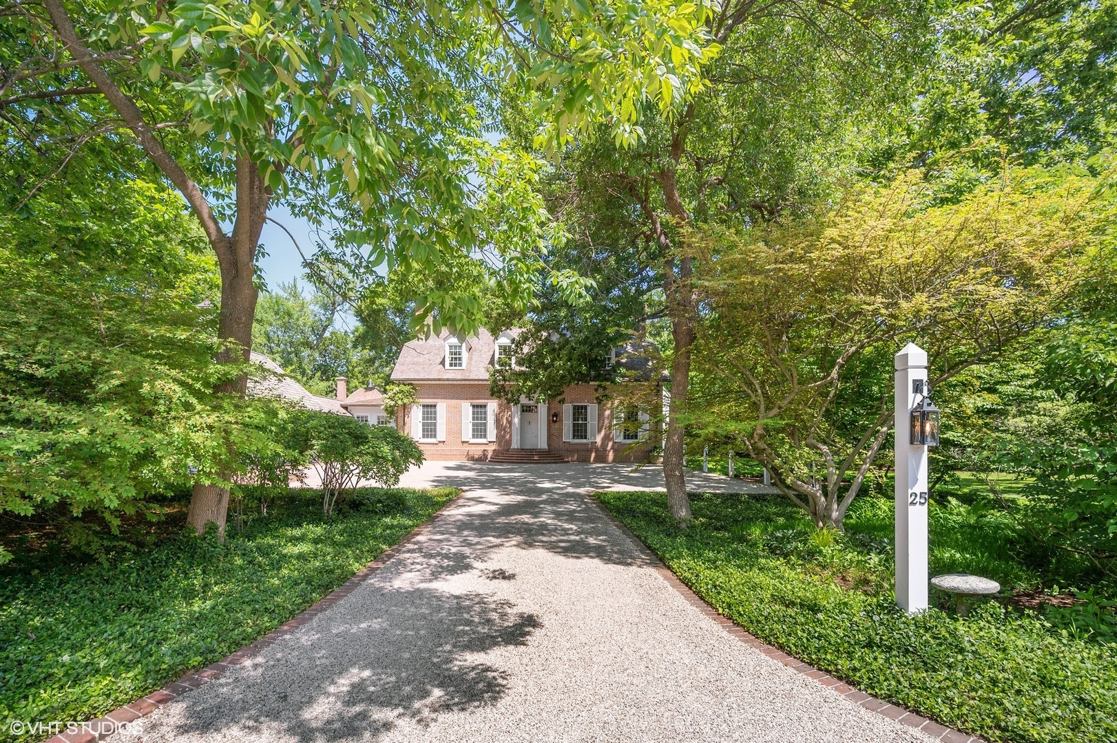 25 Indian Hill Road Winnetka, IL 60093 - Photo 2 of 84 a front view of a house with a yard and trees