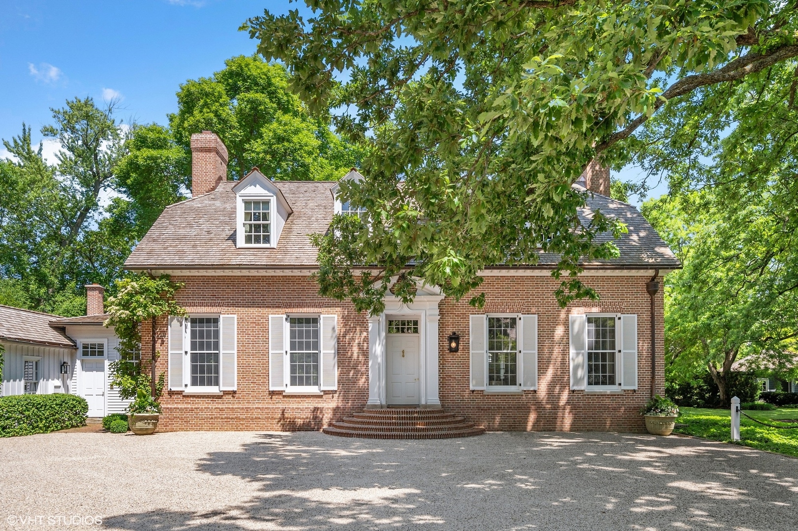 25 Indian Hill Road Winnetka, IL 60093 - Photo 6 of 84 a front view of a house with a tree