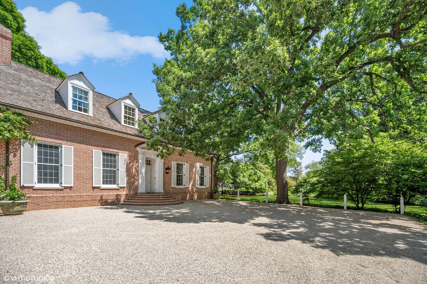 25 Indian Hill Road Winnetka, IL 60093 - Photo 81 of 84 a front view of a house with a yard and garage